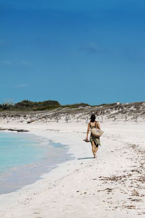 young lonely woman walking on the beachの写真素材