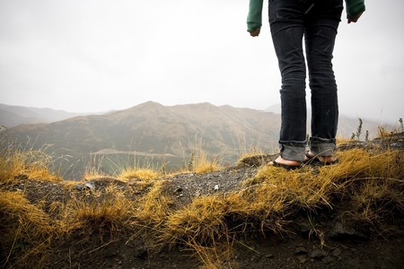A girl stands with a view from a steep vantage pointの写真素材