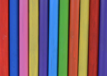 Wooden piles in rainbow coloursの写真素材