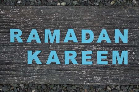 Horizontal image of the muslim saying  Ramadan Kareem  written with blue lettersの写真素材