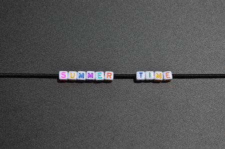 Horizontal image of the phrase 'Summer Time' written with colored letters on a black board.の写真素材
