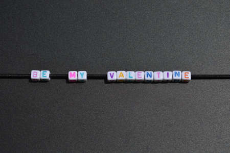 Written with colored letters in front of a black chalk boardの写真素材
