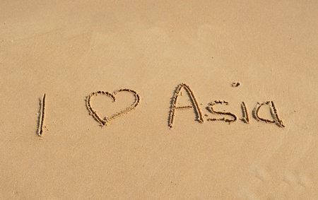 The text I love Asia written in the sand at a tropical beachの写真素材