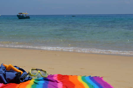 Colorful towel with beach equipment at the seaの写真素材