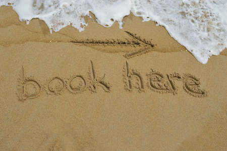 The text book here written in the sand at the beachの写真素材