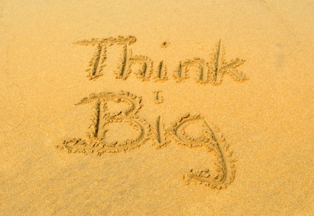The message "think BIG" in the sandの写真素材