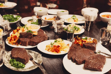 Beef tenderloin with rice and vegetables on the table.の素材