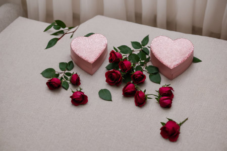 Valentine's day background with red roses and hearts on tableの素材