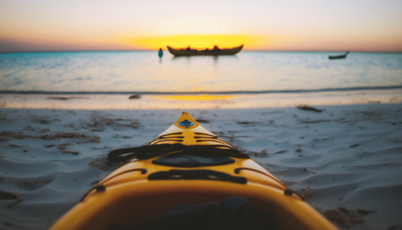 Kayak on the beach at sunset, shallow depth of field.の素材