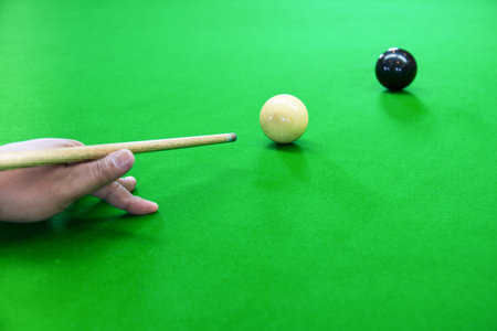 prepare to shoot a black ball that is a snooker game