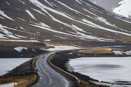 This is a photo of  car is driving on road curve in Iceland.の写真素材