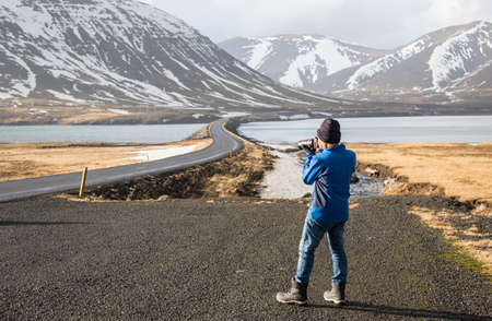 Photographer taking landscape photo in iceland.の写真素材