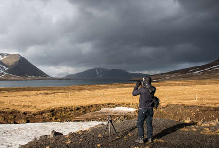 Photographer taking landscape photo in iceland.の写真素材