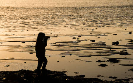 Photographer silhouette at duskの写真素材