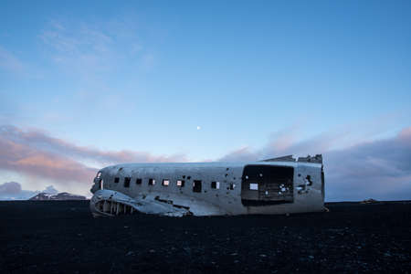 Plane crash wreckage on black sand in Icelandの写真素材