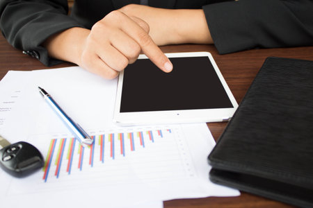 Image of male hands with digital tablet touching its screen