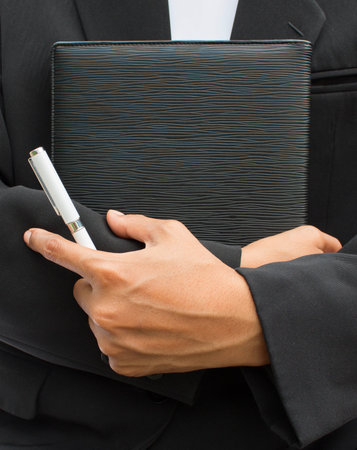 Hand holding notebook  with black cover.の写真素材