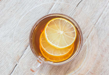 Hot tea in glass on a wooden table.の写真素材