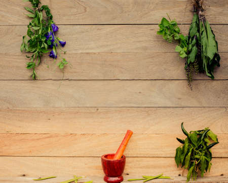 Herbs hanging on a wooden floorの写真素材