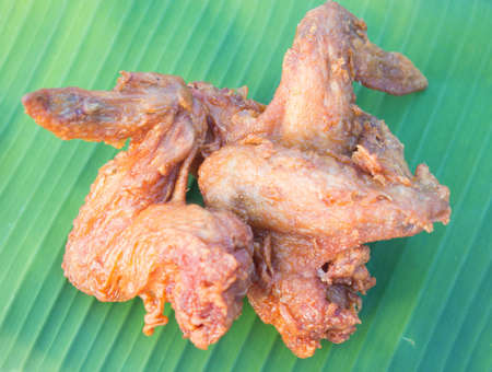 Fried chicken wings on a banana leafの写真素材