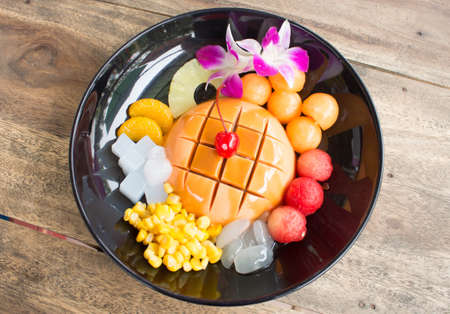 tofu pudding fruit on black plate.の写真素材
