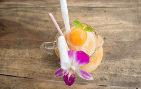 melon smoothies on a wooden tableの写真素材