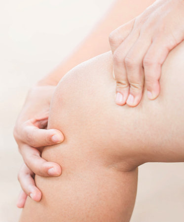 Woman suffering from knee pain.