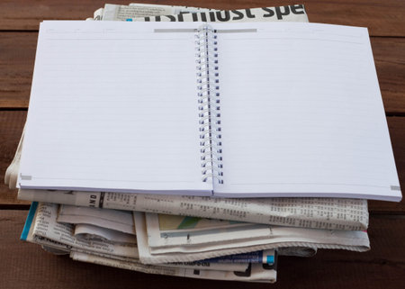 Magazines and newspapers on a wooden table.の写真素材