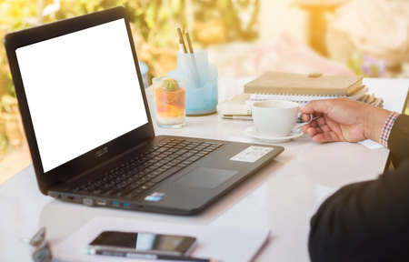 rear view of business man hands busy using laptop at office deskの写真素材