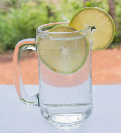 lemon soda, sparkling water, white table.