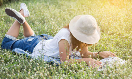 Woman reading a magazine lying Relax.の写真素材