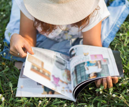 Woman reading a magazine lying Relax.の写真素材
