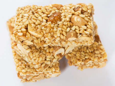 Sweet peanut and sesame candy on white background.の写真素材