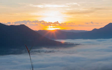 landscape with fog at mountains. with sunrise.の写真素材