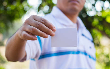 Man holding white business card.の写真素材