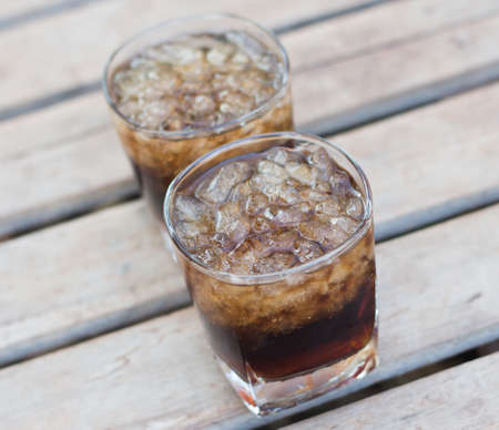 Soft drink in a glass on a wooden table.の写真素材