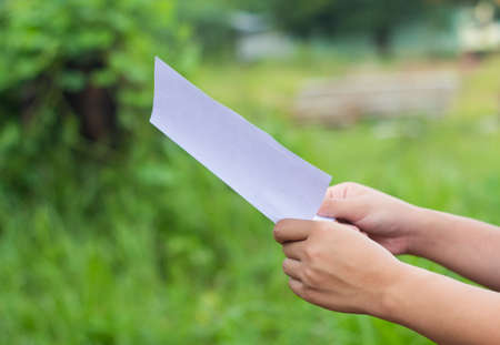 Women read magazines in garden.の写真素材