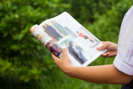 Women read magazines in garden.