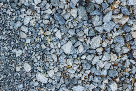 the rock with dry leaves and withered flowers background , crusted rock backgroundの写真素材