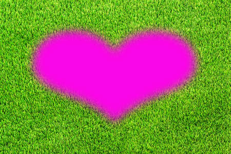 Pink heart shape in artificial grass sport for grunge background and Valentineの写真素材