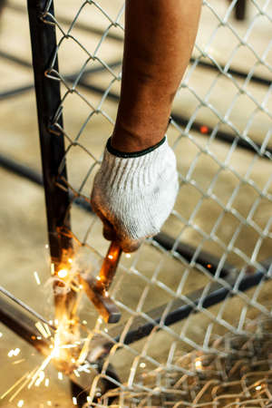 Welders welding metal and hold steel hammer in hand, Welding work.の写真素材