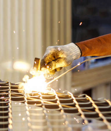 Welders welding metal and hold steel hammer in hand, Welding work.の写真素材