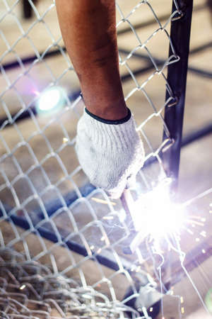 Welders welding metal and hold steel hammer in hand, Welding work.の写真素材