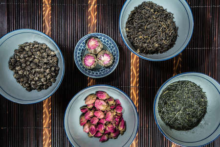 Chinese bowls filled with different kinds of Tea decorated with Chopsticksの写真素材