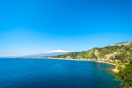 City of Taormina in Sicily with vulcano Etna in backgroundの写真素材