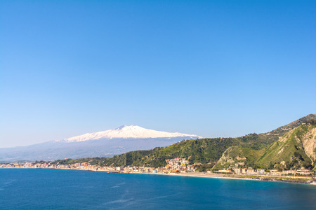 City of Taormina in Sicily with vulcano Etna in backgroundの写真素材