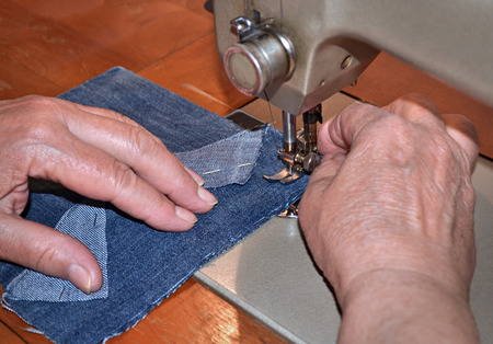 Hand sewing with a sewing machineの写真素材