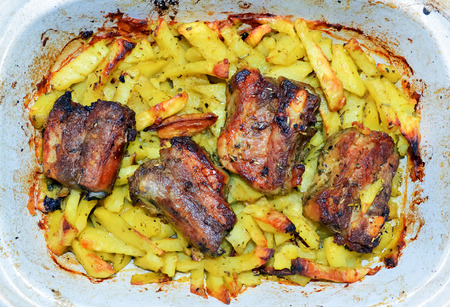 Traditional mediterranean lunch of baked potatoes and porkの写真素材