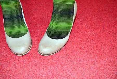 Unusual outfit combination on vibrant red backgroundの写真素材