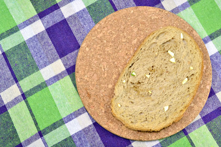 Slice of whole wheat bread surrounded with natural materials